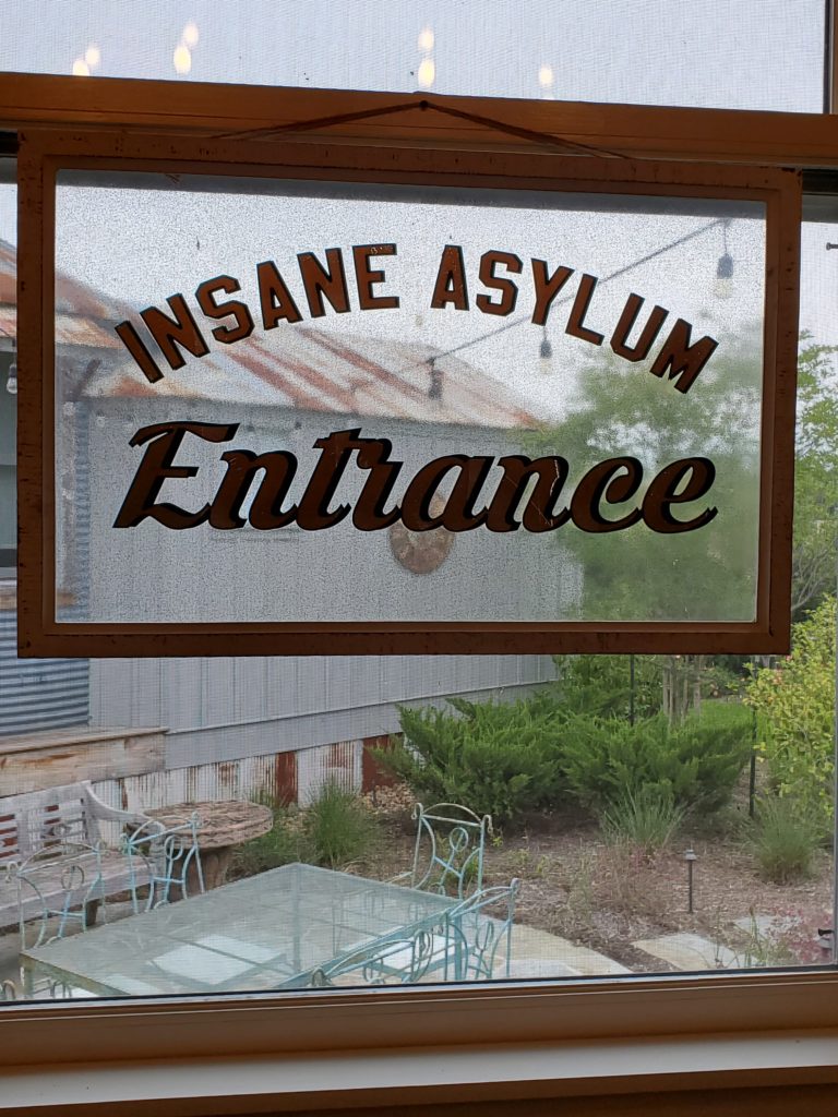 We love this repurposed entry sign, used in the silo bedroom as a window pane. (Photo by Shafik I. Rifaat)
