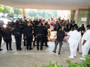 Houston Police officers salute the casket and family of George Floyd as they arrived for his funeral at the Fountain of Praise church