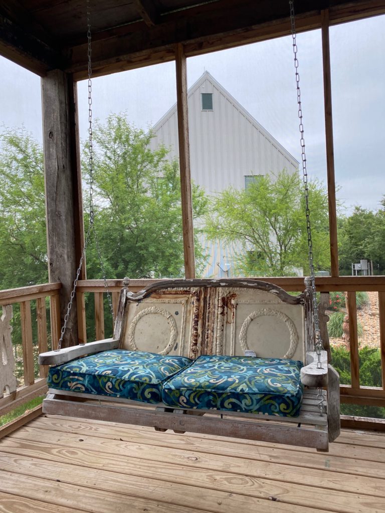 The old style country atmosphere of the silo guest cottages is ensured by the bench swing on the front porch. (Photo by Shafik I. Rifaat)