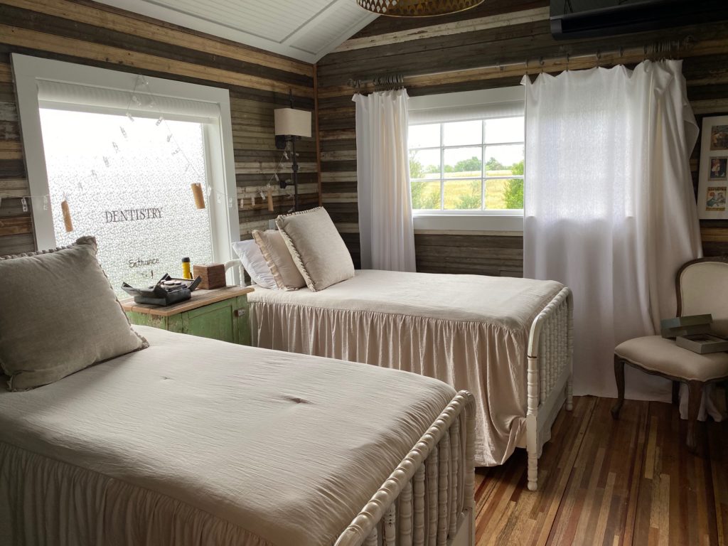 The silo bedroom is carved from wood salvaged from area homes, weathered bead board, sheet metal and even antique window frames.  (Photo by Shafik I. Rifaat)