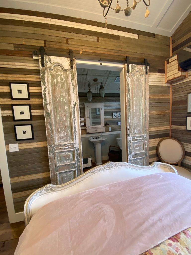 Weathered sliding doors to the bathroom   are a space saver. (Photo by Shafik I. Rifaat)