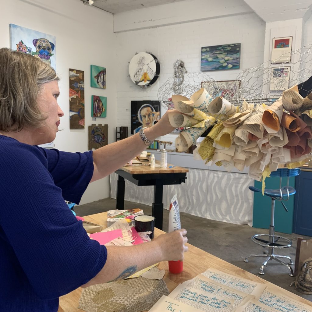 Winter Street Studios talent Stacy Gresell at work on "The Thought Hive." Visit the installation and contribute your owns works to the antique book pages when the Sawyer Yards complex reopens for Second Saturdays, Saturday, June 13. (Winter Street, Studio C6)  