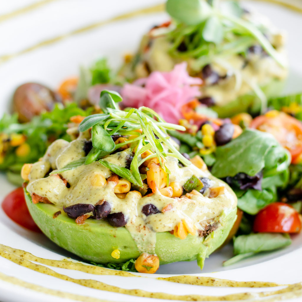 A stuffed taco-cado at TLC Vegan Kitchen is made with Impossible Crumble and black beans.