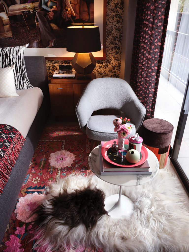 A sitting area in the bedroom with an Eero Saarinen for Knoll table from Smink and Saarinen chair from Design Within Reach. Italian pouf from Forty Five Ten. Icelandic alpaca rug acquired in London. Vintage ’70s nightstand. (Photo by Lisa Petrole)