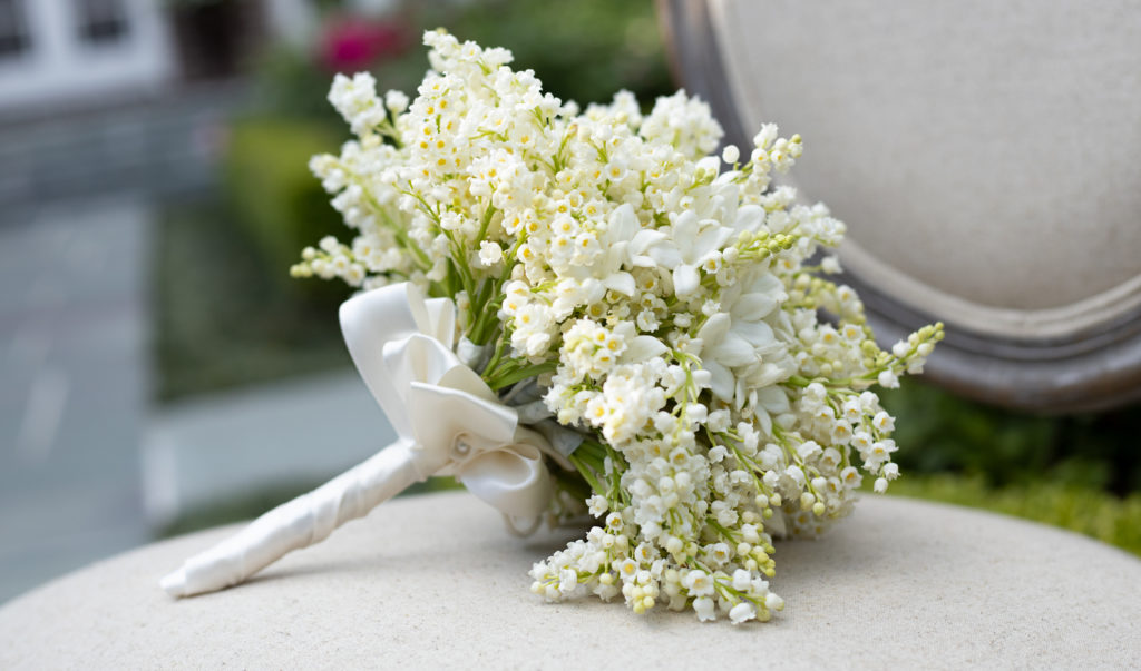 Some traditions can survive the worst of the pandemic including a romantic bouquet with lilies of the valley. (Photo courtesy of The Events Company)