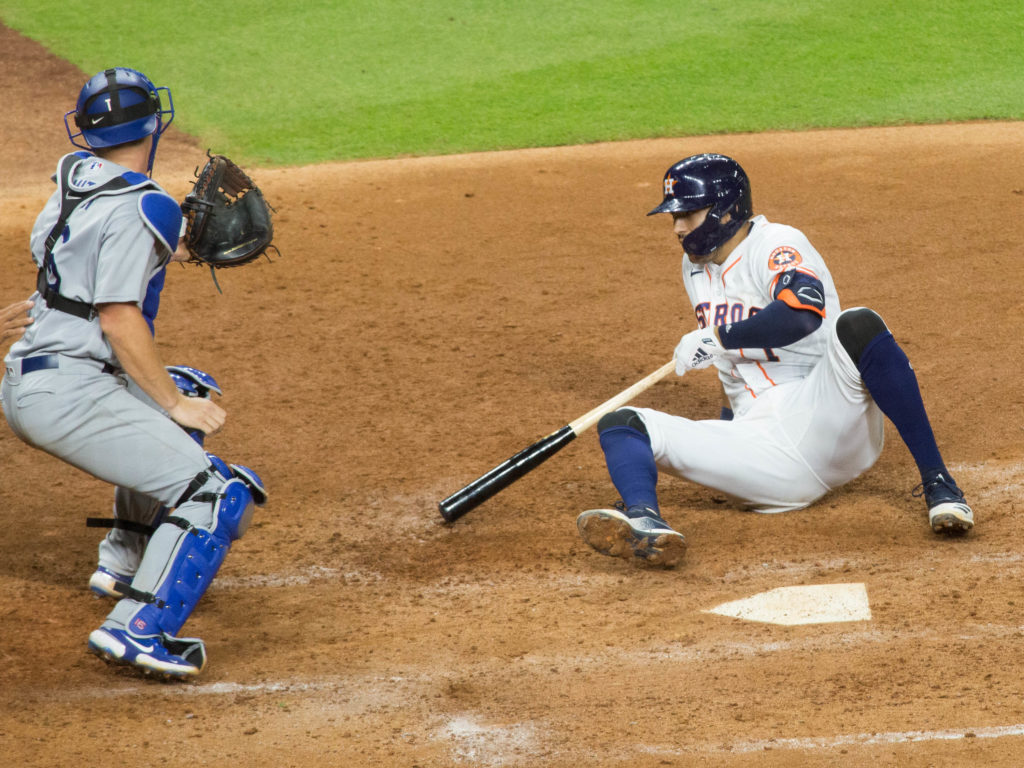 Astros shortstop Carlos Correa ends up on his rear after going down to avoid a dangerous Joe Kelly pitch. (Photo by F. Carter Smith)