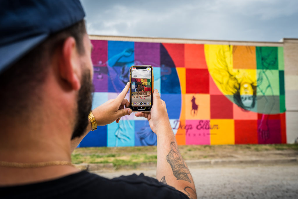 Use Snapchat to experience an augmented reality animation at the Dallas mural. (Photo by Nika Kramer)