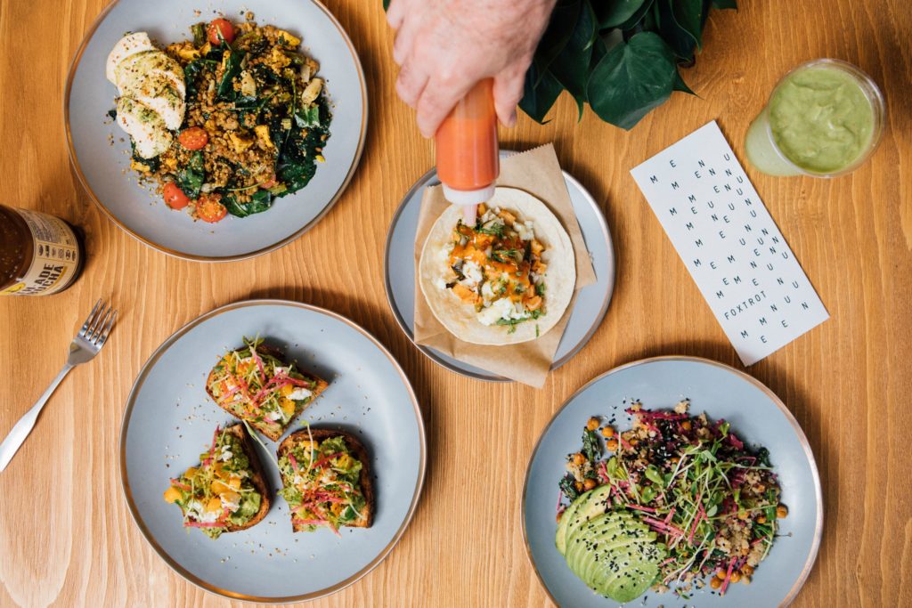 Grain bowls, salads, and sandwiches are available in the prepared foods section of Foxtrot Market.