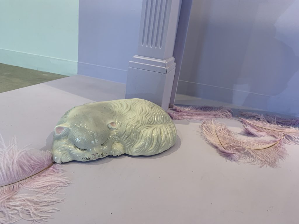 The "Heights" installation, which represents a Victorian house in the Heights, includes a ceramic cat from the '70s.