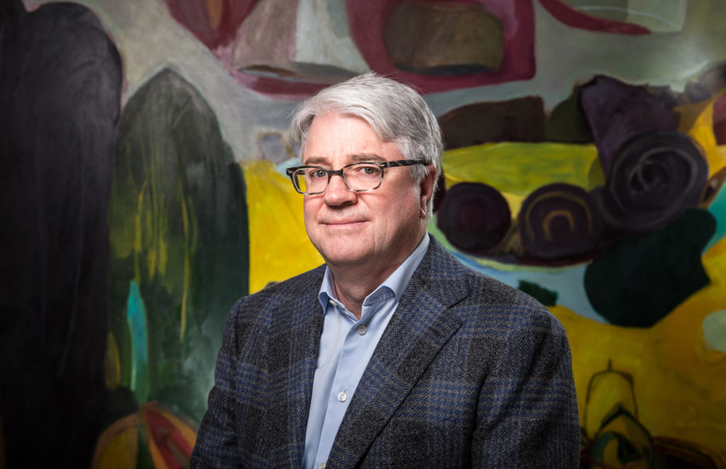 Culture Place's dynamic founder John Sughrue also serves as the chairman of Dallas Art Fair, LLC. Sughrue is shown with Julian Hatton's “Out with the Tide, 1999.” (Photo by Exploredinary/Daniel Driensky)