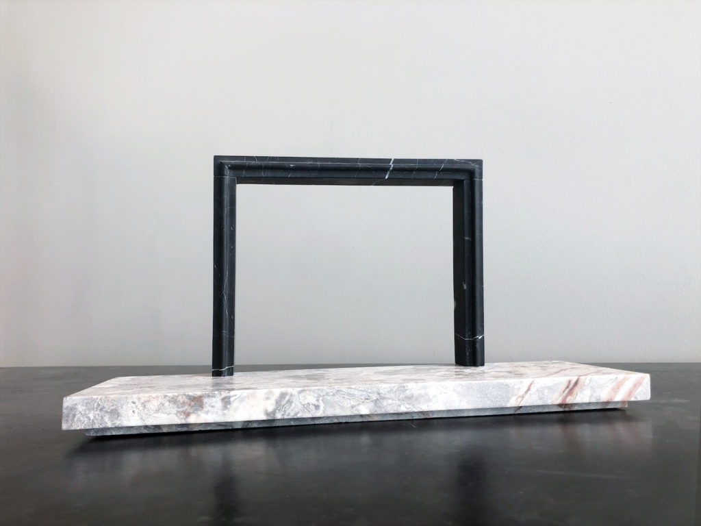 Big Sur surround in nero with a Breccia Nuvole marble hearth in a honed finish