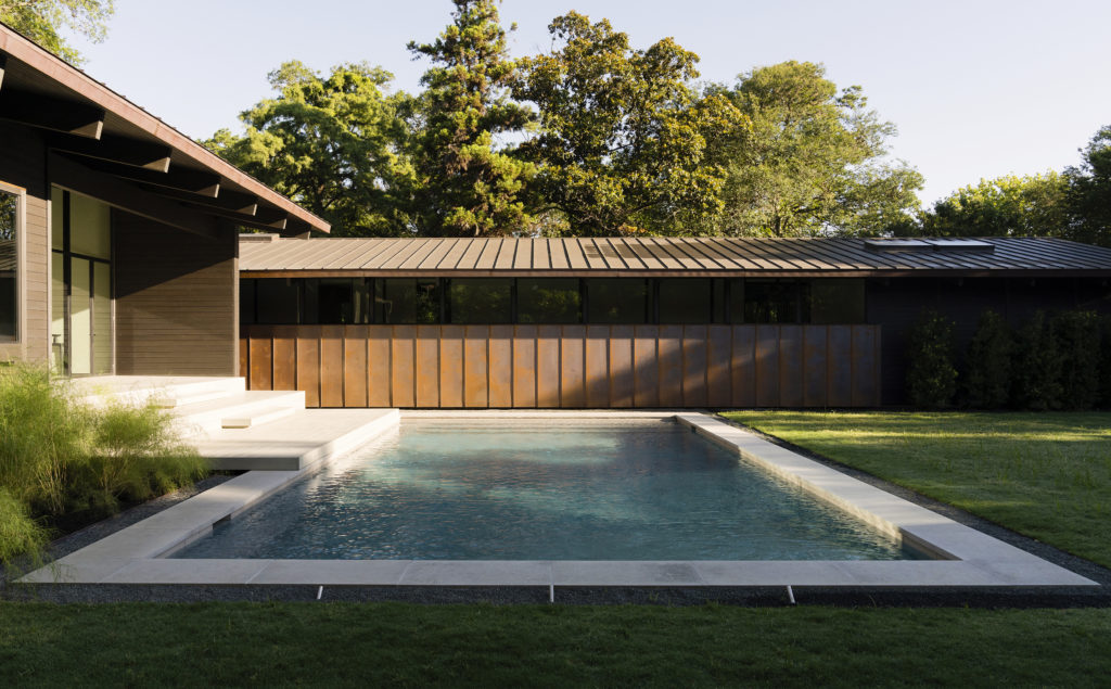 A swimming pool accents the formal interior yard. (Photo by Jack Thompson Photography)