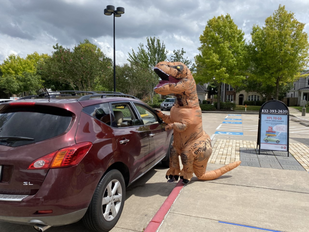 Rory the dinosaur encourages kids to keep reading during COVID-19 with HPO TO GO curbside pick up