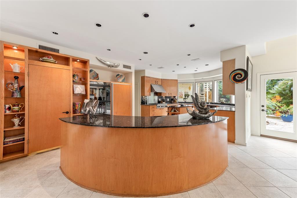 The modern kitchen boasts two islands and has views into the verdant atrium.