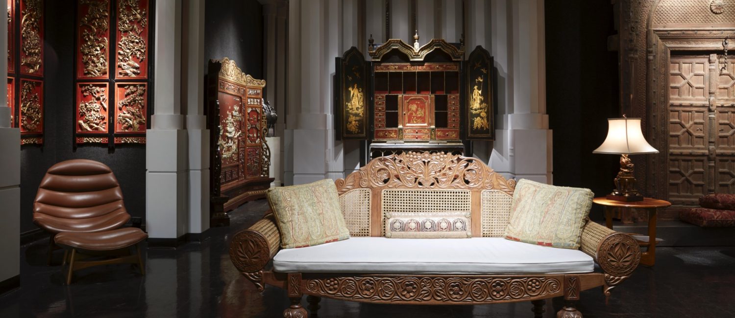 Loyd Paxton dallas A British Colonial satinwood and cane settee, ornately carved with scrolling foliage, vines, and flowers. An English chinoiserie secretary from the early 20th century has gilt painted scenes of Chinese figures, pagodas, and gardens. (Photo by Pär Bengtsson)