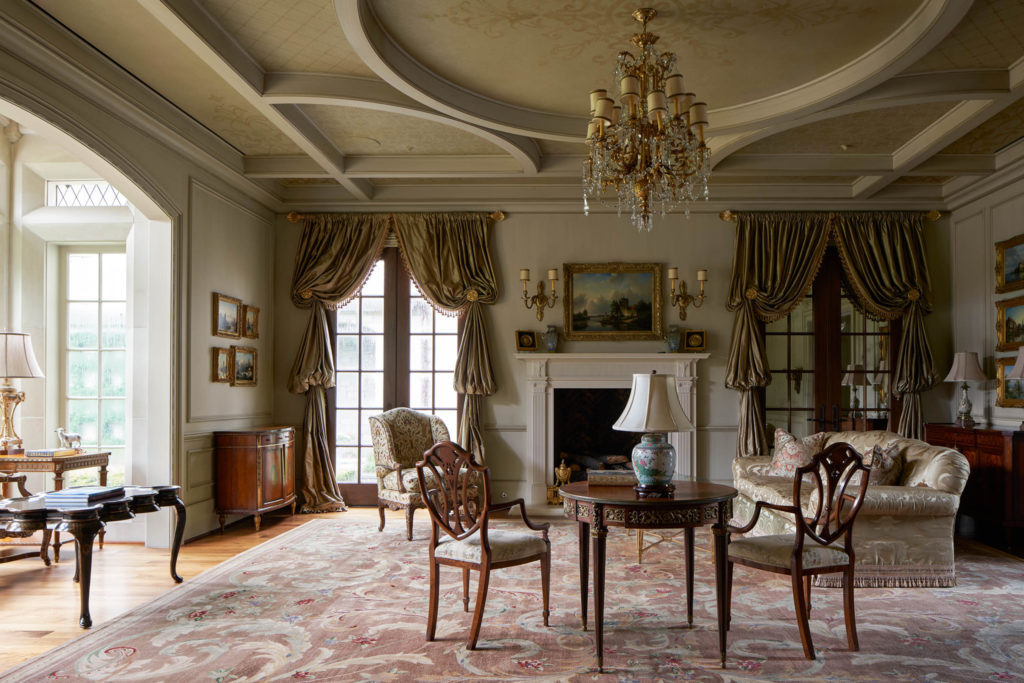 The receiving room at 120 
Carnarvon has an ornate coffered ceiling accented with gold-leaf, French bois-style paneling, and mirrored interior French doors. (Photo by Nathan Schroder/Douglas Elliman)