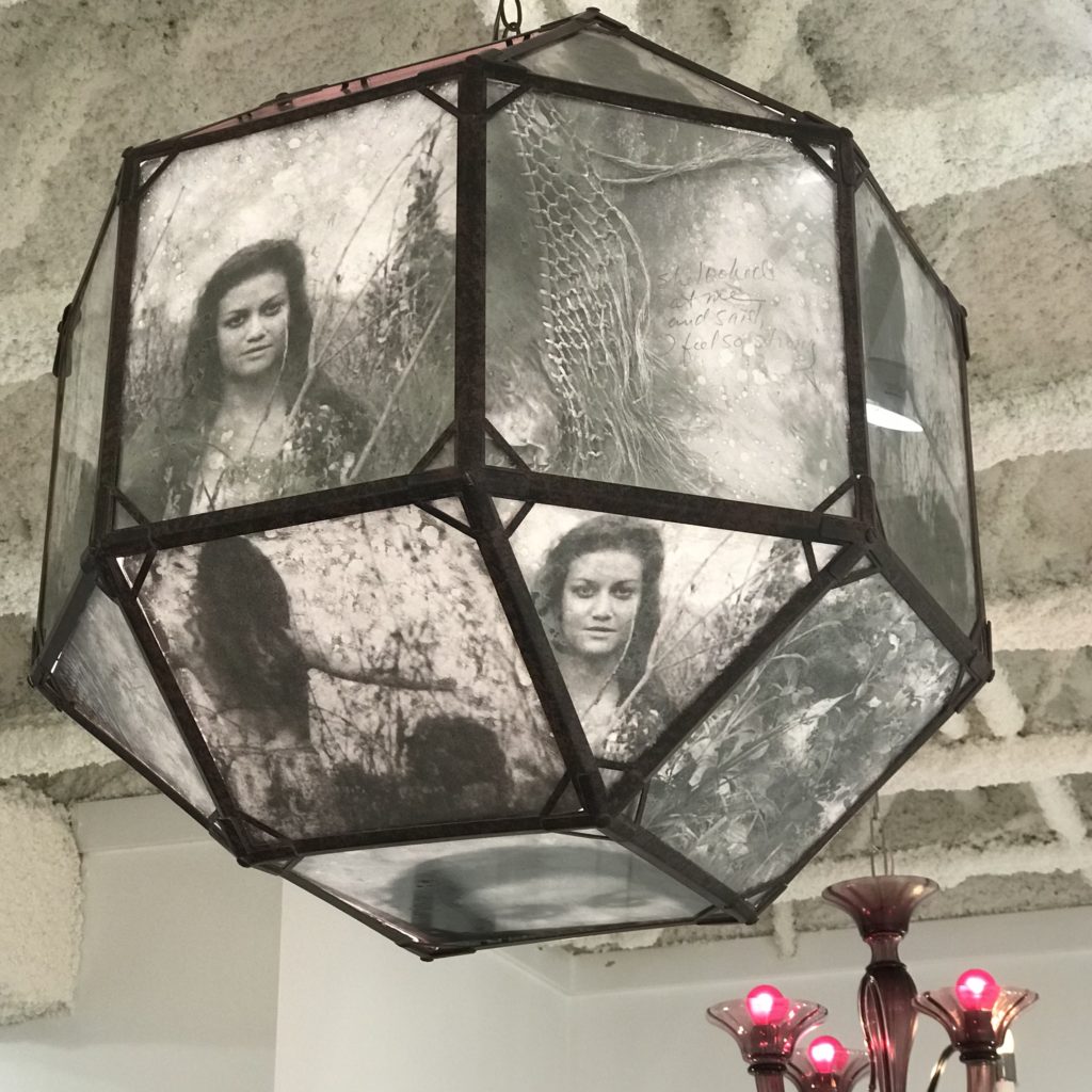 The sculpture "Remembering ..." features a lantern bearing a visual narrative of photographic images inset under glass panels. (Photo by Mary Margaret Hansen)