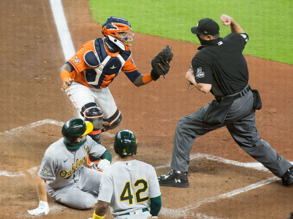 A perfect relay from left fielder Michael Brantley to Carlos Correa to catcher Martin Maldonado cut down a crucial A's run. (Photo by F. Carter Smith)