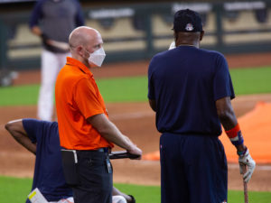 Houston Astros general manager James Click, with iPad in hand, talks with manager Dusty Baker during a practice session at Minute Maid Park as Major League Baseball plans to start the 2020 season during the coronavirus pandemic