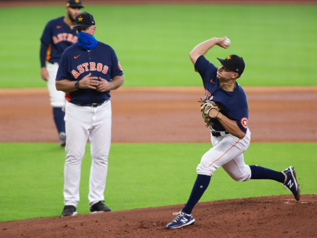 Pitching coach Brett Strom watches rookie Brandon Bialek throw. (Photo by F. Carter Smith.)