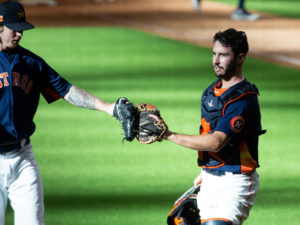 Chris Devenski and Garrett Stubbs touch gloves after ending the simulated game at Minute Maid Park