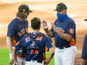 Chris Devenski and Garrett Stubbs listen to pitching Coach Brett Strom after finishing the simulated game at Minute Maid Park