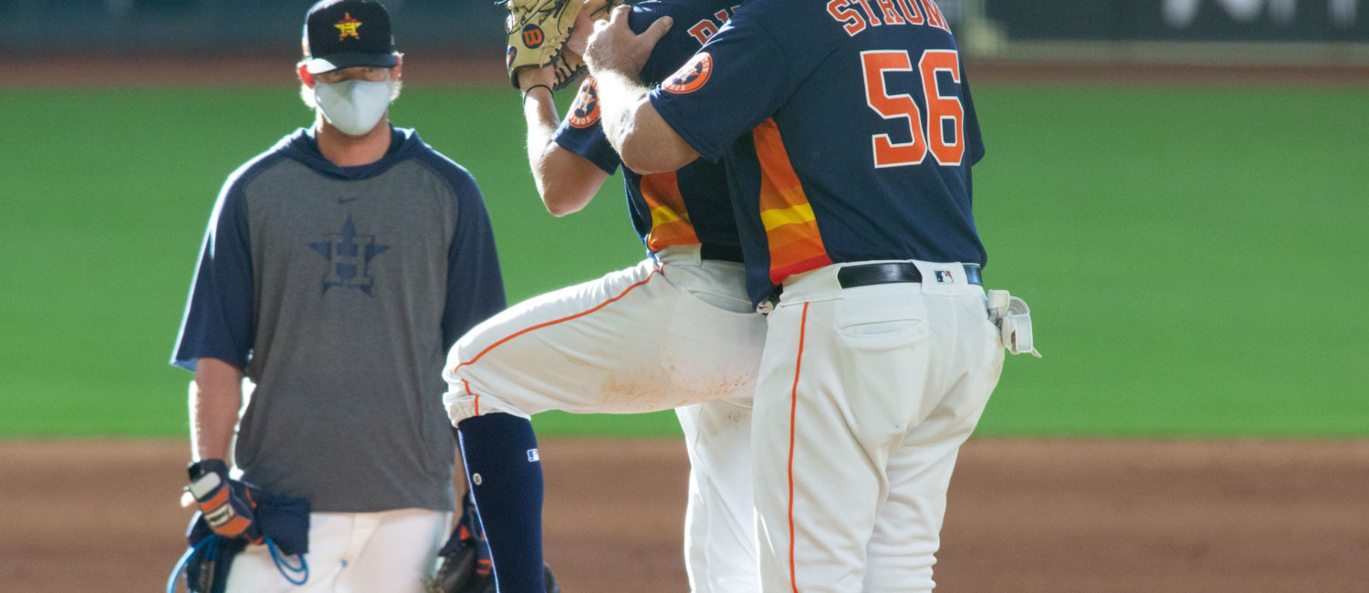 Pitching coach Brent Strom helps rookie Brandon Bielak with his pitching mechanics after pitching four innings in a simulated game at Minute Maid Park
