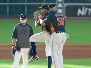 Pitching coach Brent Strom helps rookie Brandon Bielak with his pitching mechanics after pitching four innings in a simulated game at Minute Maid Park