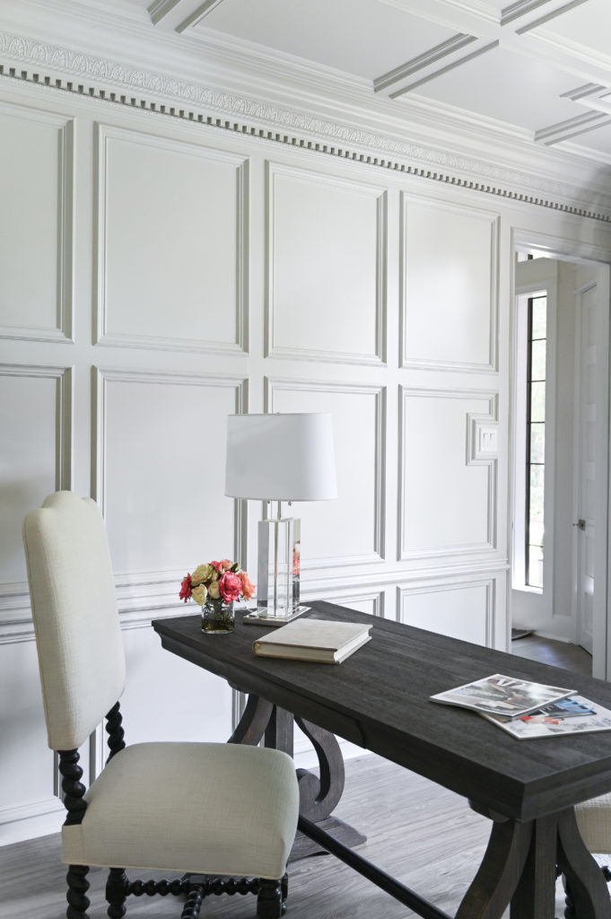 Builder Bill Hughes transformed the millwork into a showstopper with white paint that brightened the previously dark paneling.