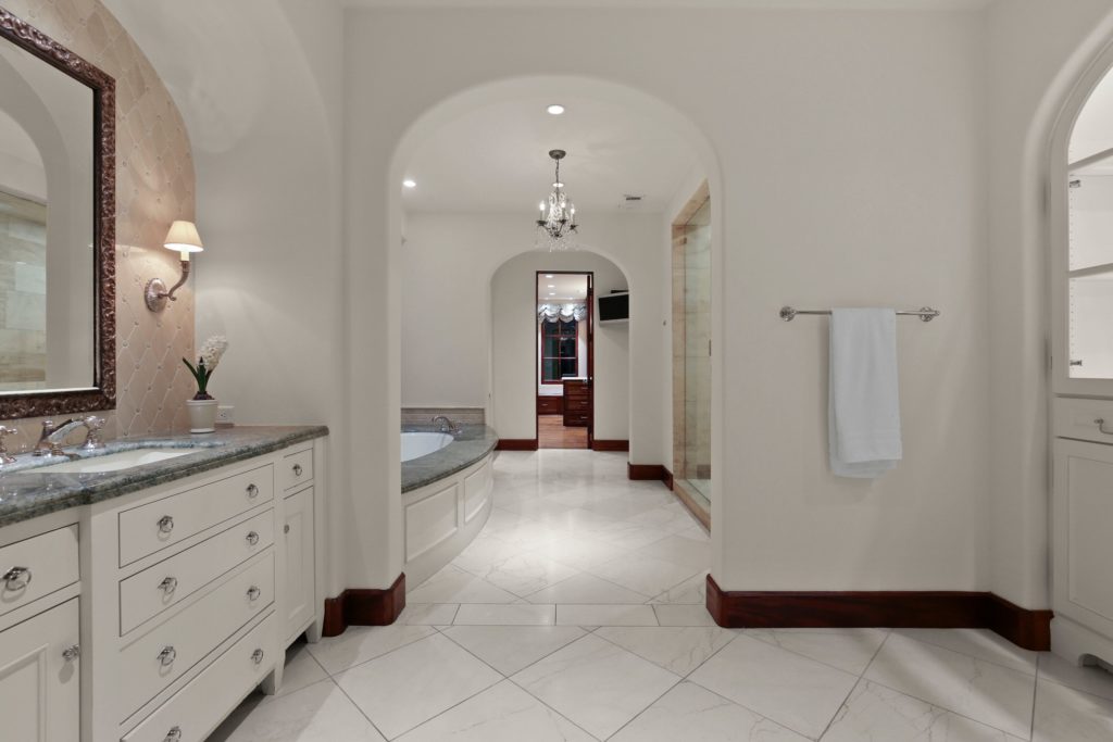 Space is separated with his and hers vanities and dressing.