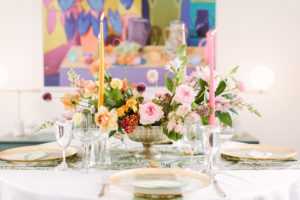 Flower Power Productions powered the table arrangements. The couples’ Daniel Gordon photograph hangs on the wall. (Photo by Mustard Seed Photography)