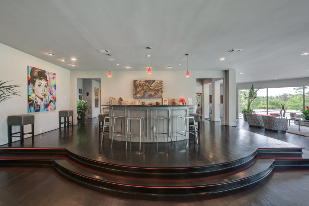 The elevated bar serves at the center of social gatherings.