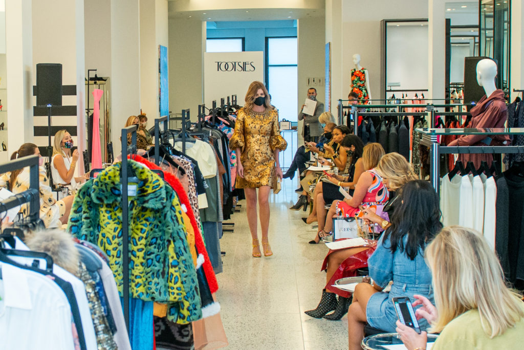 A cocktail frock with bejeweled neckline by Andrew Gn captures the imagination of the socially distanced guests at Tootsies. (Photo by Jacob Power)