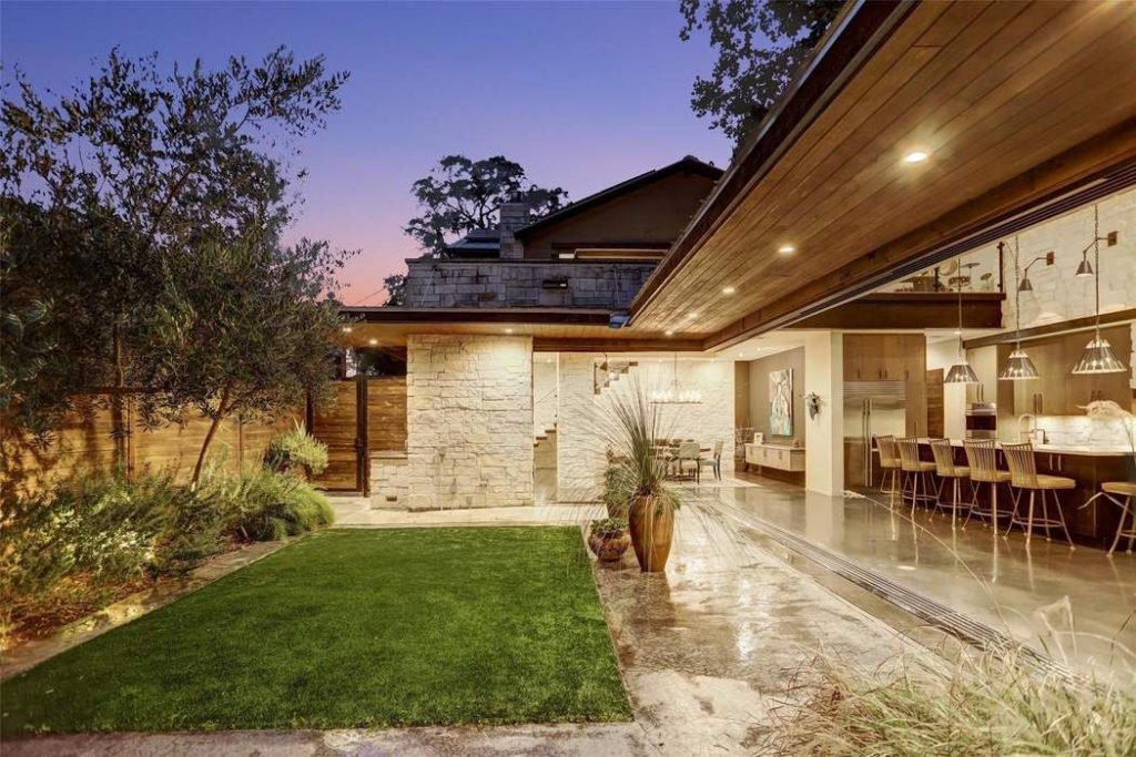 The striking facade of the two-story home celebrates the contemporary with design saluting the past.