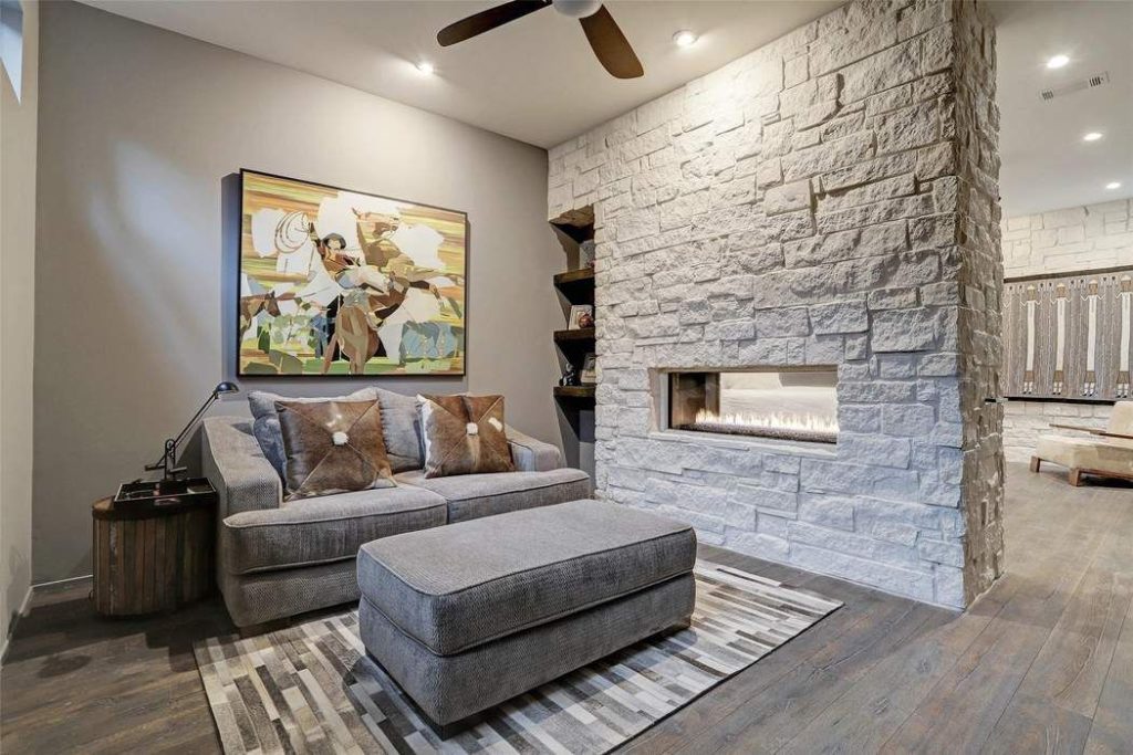 The  48-inch Montigo double-sided glass-enclosed fireplace acts as a room divider for the master flex room.