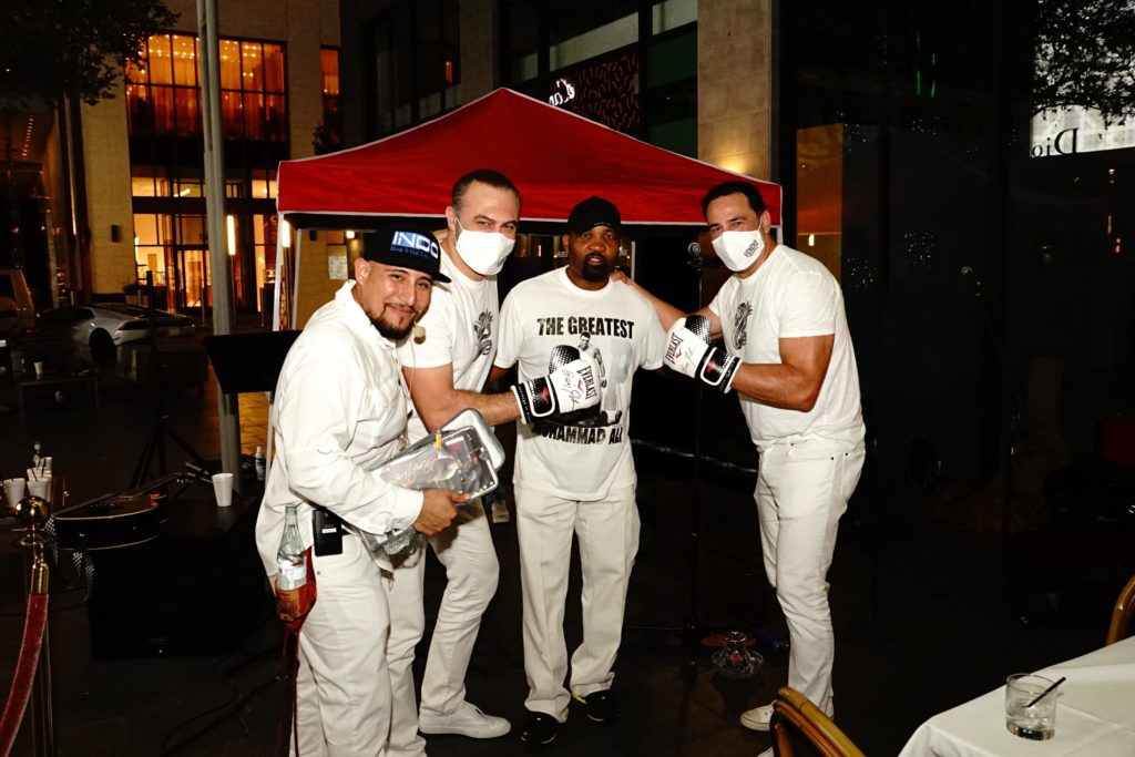 Cuerdas Sucias musician, Kiki Dikmen , two-weight world champion boxer Reggie Johnson and Javier Loya in a party mood celebrating the first anniversary of Veneno Tequila.