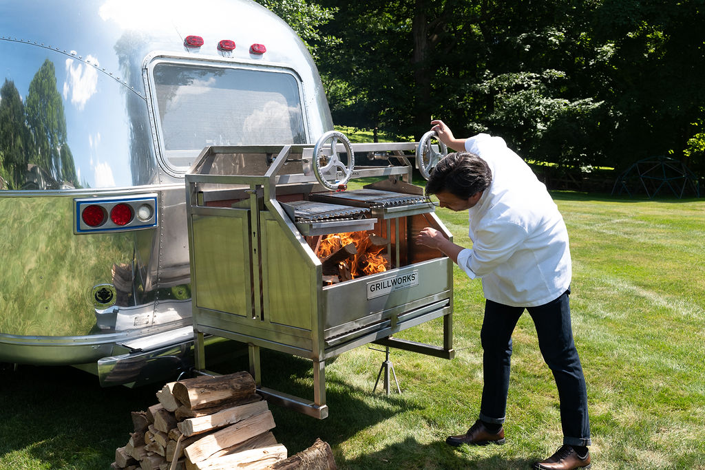 Chef Yann Nury sets up the grill at the back of his converted Airstream trailer. (Photo by Mark Mann)