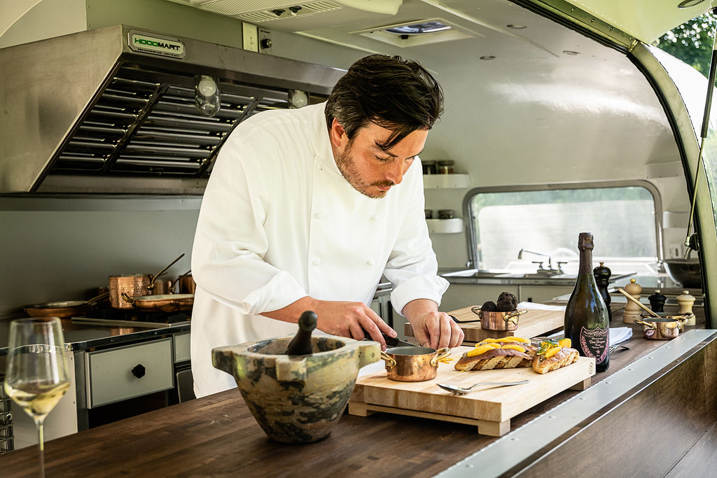 Chef Yann Nury works in the Airstream trailer kitchen that is open to diners while he prepares their meals.