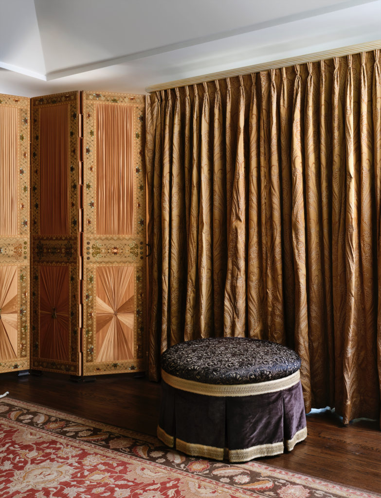 Antique silks cover walls, ottoman, and floor screen in a guest bedroom. (Photo by Lisa Petrole, Styled by Michelle Aviña)