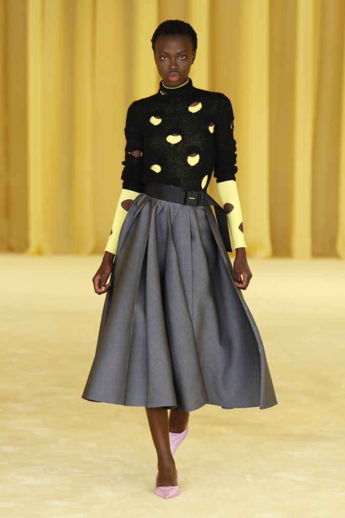 Prada sweater with cut-out circles and full skirt. (Photo courtesy of Prada)