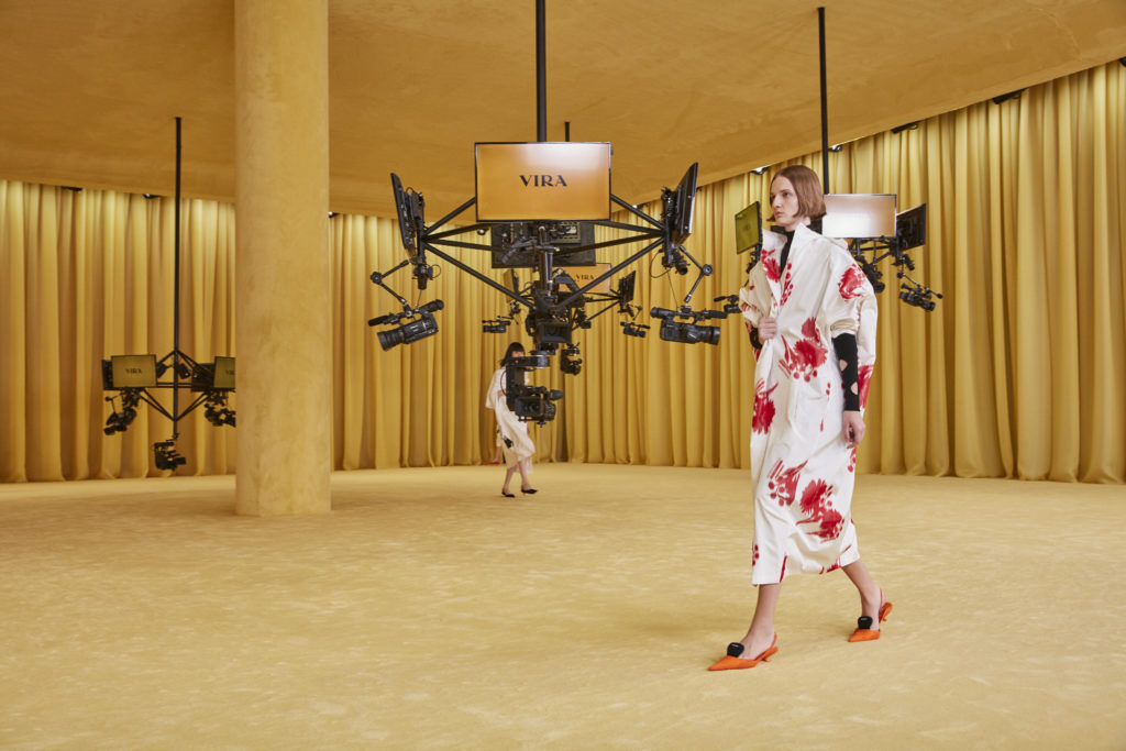 Prada cocoon coat. The show took place in an empty room with television cameras and monitors posted from th ceiling. (Photo courtesy of Prada)