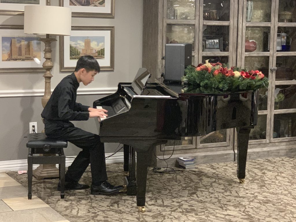 Teaching To Give president Weillison Hsu plays piano for residents at a nursing home.
