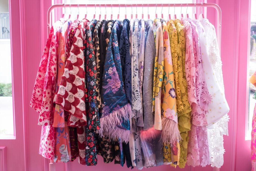 Vibrant hues befit the designs, which are marked by heart- and star-shaped lace, ostrich feathers, metallic brocades, and animal-print sequins.