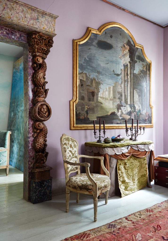 Werner-Vaughn painted the doorway surround as faux marbre, then added an antique architectural carving. Walls are painted a dusky pink from Farrow & Ball. Chair is 18th century. (Photo by Lisa Petrole, Art Direction by Michelle Aviña)