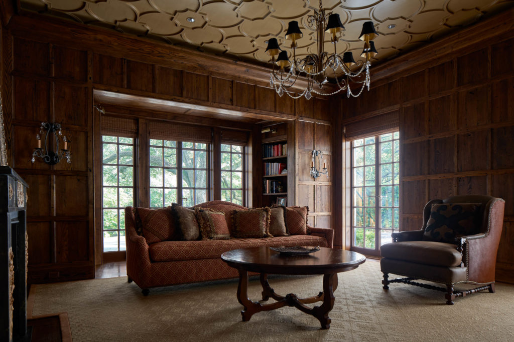 Wormy chestnut covers the walls of the den at 2 Longfellow Lane where one of seven fireplaces provides a cozy warmth. The house on the National Register of Historic Places is on the market for $12,200 million.  (Photo by Nathan Schroder/Douglas Elliman)