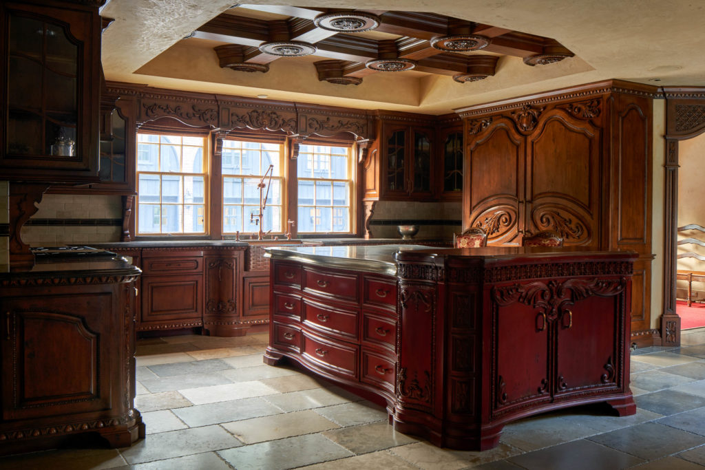 The kitchen has over $1M in custom cabinets made out of state and installed separately. The box-beam ceiling over the Pewter island in the kitchen took over 7 weeks to install. (Photo by Nathan Schroder/Douglas Elliman)