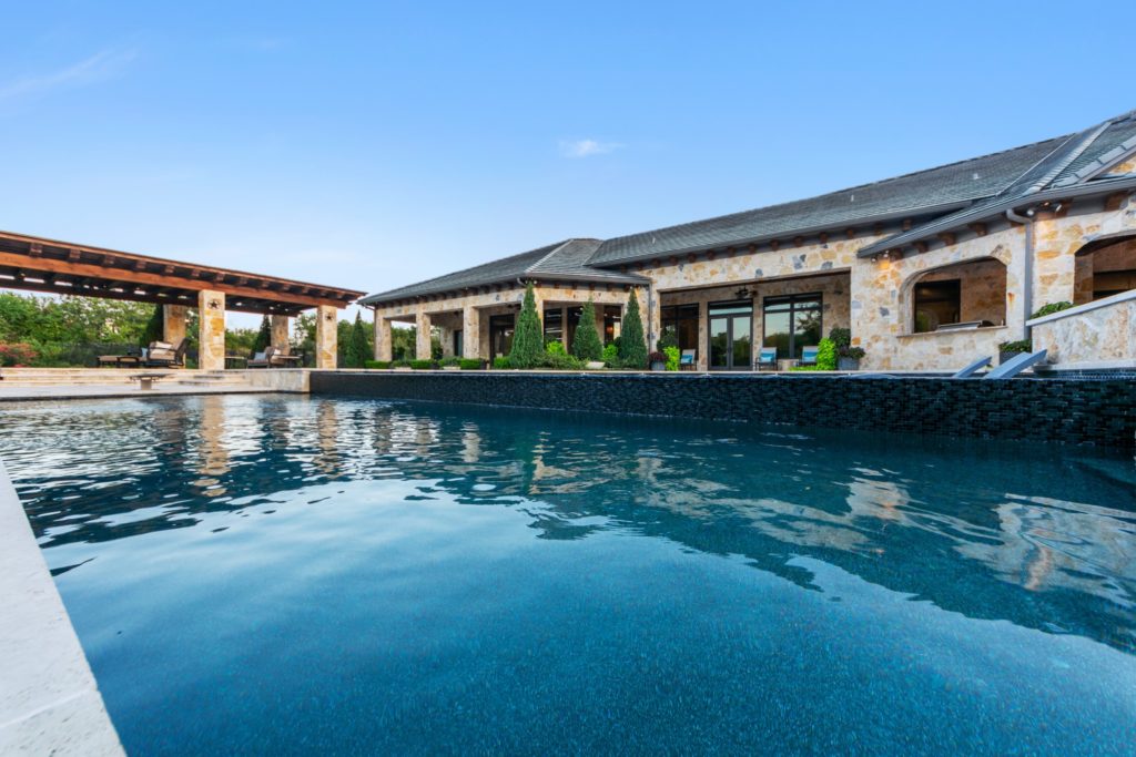 The 8,000 square foot house was built around the 85,000 gallon swimming pool.