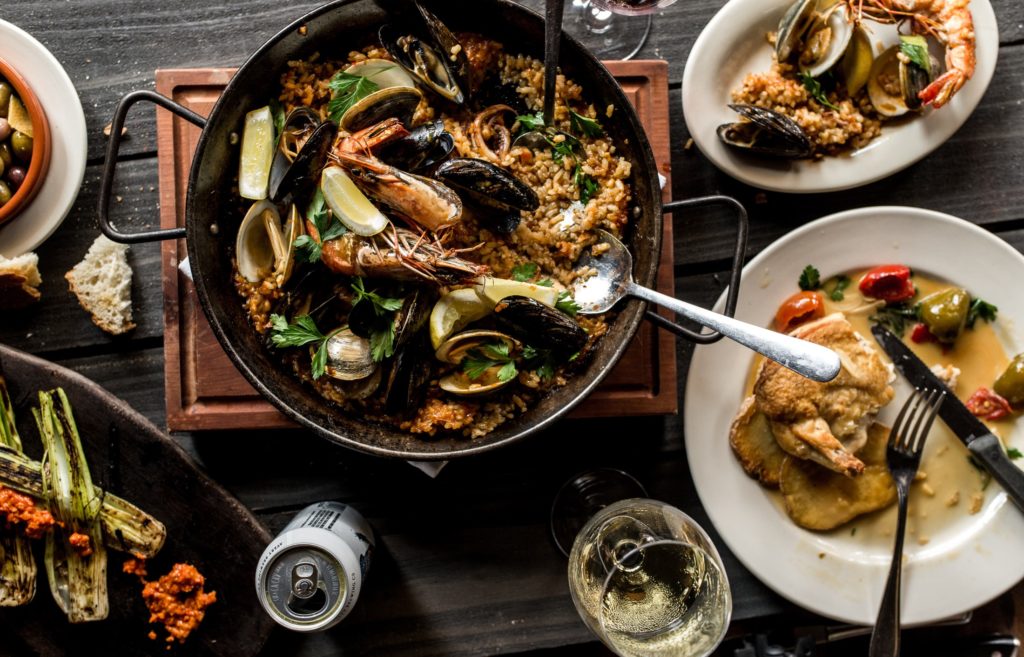 Large plates at Barcelona include paella, chicken, and Branzino. (Photo by Manny Vargas)