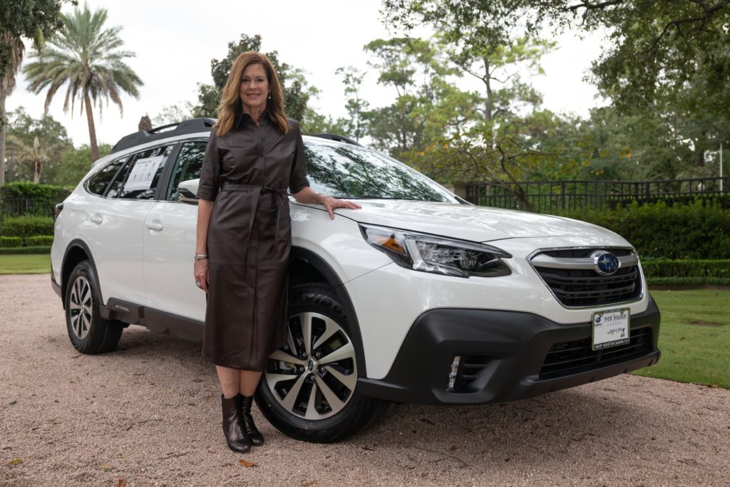 West Houston Subura's Gloria Meszaros with the 2021 Subaru Outback Premium raffled at the CAP gala. (Photo by Daniel Ortiz)