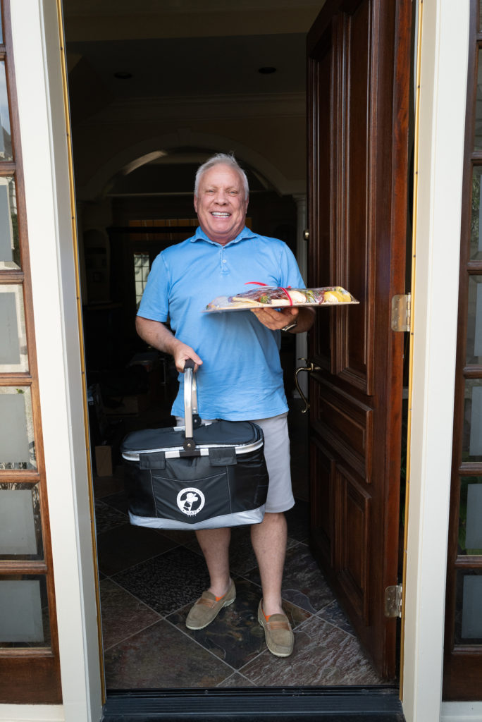 Gregg Miller receives his CAP gala picnic basket filled with fuel for partying to the sounds of The Fab 5. (Photo by Daniel Ortiz)